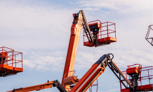 Five orange boom lifts